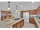 Spacious kitchen featuring granite countertops, stainless steel appliances, and light wood cabinets at 7405 Blue Sage Ct, Las Vegas, NV 89129