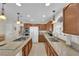 Spacious kitchen featuring granite countertops, stainless steel appliances, and light wood cabinets at 7405 Blue Sage Ct, Las Vegas, NV 89129