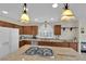 Bright kitchen featuring granite countertops, center island with cooktop, and stainless steel appliances at 7405 Blue Sage Ct, Las Vegas, NV 89129