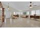 Spacious living room featuring tile flooring, plantation shutters, high ceilings, and classic furnishings at 7405 Blue Sage Ct, Las Vegas, NV 89129