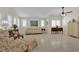 Bright living room with tile flooring, neutral walls, plantation shutters and classic furnishings at 7405 Blue Sage Ct, Las Vegas, NV 89129