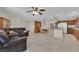Open-concept living space with tile floors seamlessly connects the living room and kitchen at 7405 Blue Sage Ct, Las Vegas, NV 89129