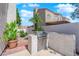 Outdoor kitchen area features a stainless steel grill, countertop, and lush tropical foliage enhancing the outdoor living space at 7405 Blue Sage Ct, Las Vegas, NV 89129