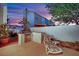 Outdoor kitchen with BBQ, lounge chair, and serene desert landscaping, ideal for relaxation at 7405 Blue Sage Ct, Las Vegas, NV 89129