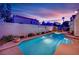 Backyard pool at twilight with colorful sky and garden at 7405 Blue Sage Ct, Las Vegas, NV 89129