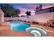 This backyard features a sparkling pool and spa, perfect for outdoor entertaining at 7405 Blue Sage Ct, Las Vegas, NV 89129