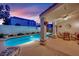 Stunning pool view with a covered patio, outdoor seating, and a well-maintained yard at 7405 Blue Sage Ct, Las Vegas, NV 89129