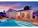 Backyard swimming pool with covered patio and desert landscaping at 7405 Blue Sage Ct, Las Vegas, NV 89129