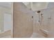 Walk-in shower showcasing stone-look tile with a built-in seat and niche at 7405 Blue Sage Ct, Las Vegas, NV 89129
