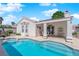 This backyard has a private pool with steps into the water and a covered patio for outdoor relaxation and enjoyment at 7405 Blue Sage Ct, Las Vegas, NV 89129