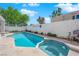 Backyard features a refreshing swimming pool and spa, surrounded by a concrete patio and privacy wall for relaxing outdoor enjoyment at 7405 Blue Sage Ct, Las Vegas, NV 89129