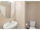 Powder room with a modern pedestal sink and toilet at 7826 Shingle Beach St, Las Vegas, NV 89166