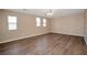 Bedroom with hardwood floors, neutral walls, and bright windows at 7826 Shingle Beach St, Las Vegas, NV 89166