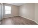 This bedroom features hardwood floors, a window, neutral paint, and a closet at 7826 Shingle Beach St, Las Vegas, NV 89166