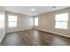 A bedroom with hardwood floors and multiple windows bringing in great natural light at 7826 Shingle Beach St, Las Vegas, NV 89166