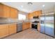 Well-lit kitchen featuring stainless steel appliances and wooden cabinets at 7826 Shingle Beach St, Las Vegas, NV 89166