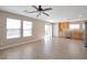 Open living space with wood-look flooring, ceiling fan and sliding glass doors at 7826 Shingle Beach St, Las Vegas, NV 89166