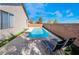 Serene backyard featuring a sparkling pool, lounge chairs, and well-maintained greenery at 792 Valley Rise Dr, Henderson, NV 89052