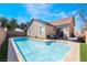 Stunning backyard with a sparkling pool, patio furniture, and lush landscaping for outdoor enjoyment at 792 Valley Rise Dr, Henderson, NV 89052