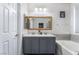 Stylish bathroom featuring double sinks, a large mirror, and a bathtub with tiled accents at 792 Valley Rise Dr, Henderson, NV 89052