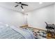 Spacious bedroom with wood floors includes a study desk, ceiling fan, and a comfortable bed at 792 Valley Rise Dr, Henderson, NV 89052