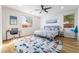 Inviting main bedroom with two windows, ceiling fan, and an accent rug on hardwood flooring at 792 Valley Rise Dr, Henderson, NV 89052