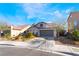 Inviting single-Gathering home with a two-car garage and desert landscaping, featuring a unique turret design at 792 Valley Rise Dr, Henderson, NV 89052