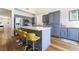 Bright kitchen features stainless steel appliances, grey cabinetry, and a white quartz countertop island with seating at 792 Valley Rise Dr, Henderson, NV 89052