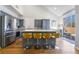 Stylish kitchen with gray cabinetry, quartz countertops, a large island with seating, and stainless steel appliances at 792 Valley Rise Dr, Henderson, NV 89052