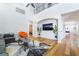 Bright living room with a high ceiling, hardwood floors, modern furnishings, and a view of the second-floor balcony at 792 Valley Rise Dr, Henderson, NV 89052