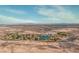 An aerial view showcasing a community lake area amid the desert landscape with mountains in distance at 8228 Fritzen Ave, Las Vegas, NV 89131