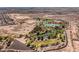 An aerial view of the area featuring a lake and community recreational area surrounded by desert at 8228 Fritzen Ave, Las Vegas, NV 89131