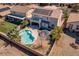 Aerial view of backyard featuring a sparkling pool, green grass, patio and landscaping at 8228 Fritzen Ave, Las Vegas, NV 89131