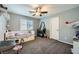 This ' bedroom has a ceiling fan, carpet and natural light from the window at 8228 Fritzen Ave, Las Vegas, NV 89131
