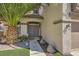 Front entrance featuring double doors, green lawn, and decorative plants in front of a home at 8228 Fritzen Ave, Las Vegas, NV 89131