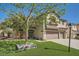 Two-story home with lush landscaping and a well-manicured lawn and a three car garage at 8228 Fritzen Ave, Las Vegas, NV 89131