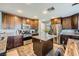 Bright kitchen featuring stainless steel appliances, granite countertops, wood cabinets and island at 8228 Fritzen Ave, Las Vegas, NV 89131