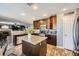 Open kitchen with stainless steel appliances, central island with granite countertops and adjacent dining area at 8228 Fritzen Ave, Las Vegas, NV 89131