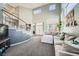 View of the living room with sofa, fireplace, staircase, and bright natural light at 8228 Fritzen Ave, Las Vegas, NV 89131