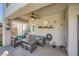 This covered patio has comfortable seating and a ceiling fan at 8228 Fritzen Ave, Las Vegas, NV 89131