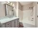 Elegant bathroom featuring a marble vanity, a well-lit mirror, and a bathtub-shower combo, creating a serene ambiance at 830 Carnegie St # 724, Henderson, NV 89052