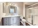 Bright bathroom featuring modern vanity, framed mirror, and glass-enclosed shower at 830 Carnegie St # 724, Henderson, NV 89052