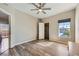 Airy bedroom with a ceiling fan, bright window, and en-suite door for added privacy and accessibility at 830 Carnegie St # 724, Henderson, NV 89052