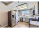 Well-lit kitchen with stainless steel appliances, stylish countertops, and a window offering scenic views at 830 Carnegie St # 724, Henderson, NV 89052