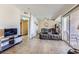 Living room featuring a sectional sofa, tile floors and a large glass sliding door to the exterior at 830 Carnegie St # 724, Henderson, NV 89052