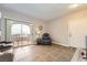 Open living area with neutral walls, tile flooring, and sliding glass doors to outdoor balcony at 830 Carnegie St # 724, Henderson, NV 89052