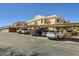 Exterior parking area with covered spaces in front of the condo building at 830 Carnegie St # 724, Henderson, NV 89052