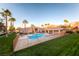Community pool featuring clear water, a spacious sun deck and tall palm trees in a desert community at 830 Carnegie St # 724, Henderson, NV 89052