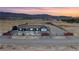 An aerial view of a single-story house with desert landscaping, a two-car garage, and scenic mountain views at 9090 Josepine St, Pahrump, NV 89048