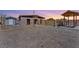 A view of the gravel-filled backyard showcasing the house, gazebo and additional structures at 9090 Josepine St, Pahrump, NV 89048